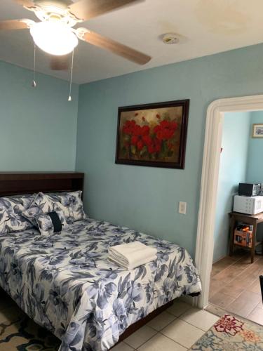 a bedroom with a bed and a painting on the wall at The Insight room is well-appointed in Pawtucket