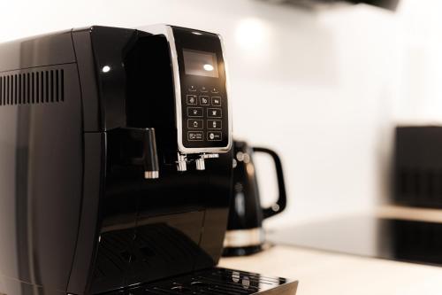 a black microwave sitting on top of a counter at Royal Apartments & Spa Zakopane-Cyrhla in Zakopane