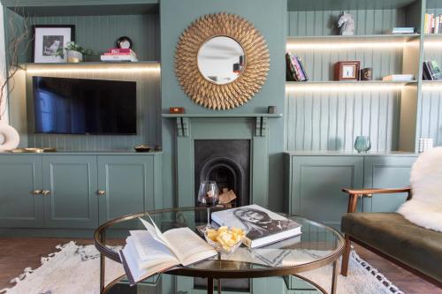 a living room with a fireplace and a glass table at Luxury Townhouse - close to castle & town - perfect stylish stay, sunny private courtyard, dog friendly in Warwick