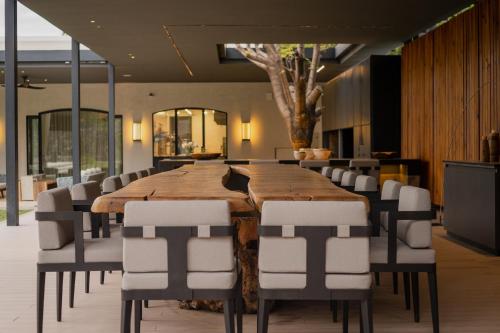 a conference room with a large wooden table and chairs at Susana Balbo Winemaker´s House in Ciudad Lujan de Cuyo