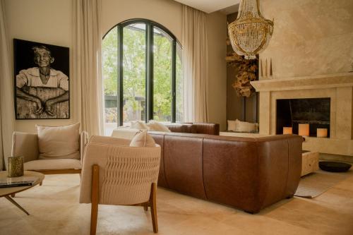 a living room with a couch and a fireplace at Susana Balbo Winemaker´s House in Ciudad Lujan de Cuyo