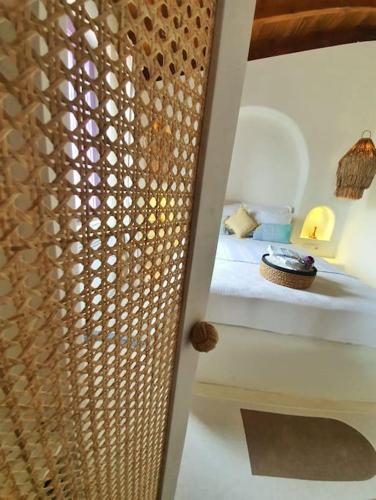 a bedroom with a bed with a wooden curtain at Mor Panjurlu Bohem Tasarım Ev - Kazdağları & Deniz in Ayvacık