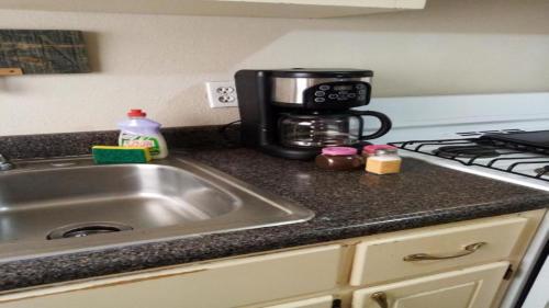 a kitchen counter with a sink and a coffee maker at Apartment Summer in Puerto Peñasco