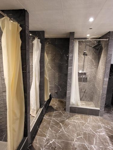 a bathroom with a shower with a shower curtain at Hostel Hakuna Matata in Dubrovnik