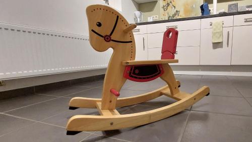 a wooden rocking horse sitting in a kitchen at Vertentenhuis in Hamme