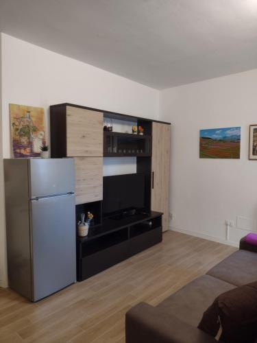 a kitchen with a stainless steel refrigerator in a room at La Castellana in Spina