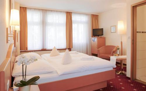 
Ein Bett oder Betten in einem Zimmer der Unterkunft Ferien- und Wellnesshotel Waldfrieden
