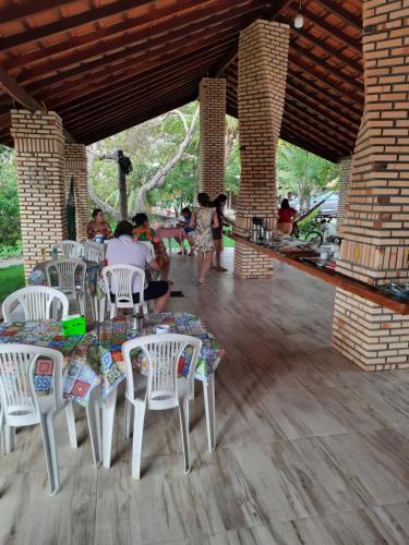 a group of people sitting at tables in a pavilion at Pousada do Rancho in Barreirinhas