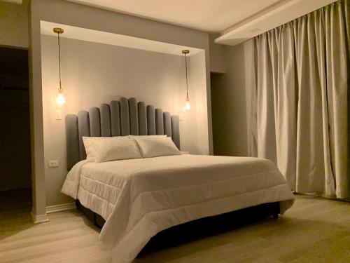 a bedroom with a large bed and a window at Penthouse - Vista Hermosa Apartments in Filandia