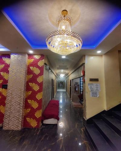 a ceiling with a chandelier and a hallway with a floor at HOTEL SUKHMANI in Guwahati