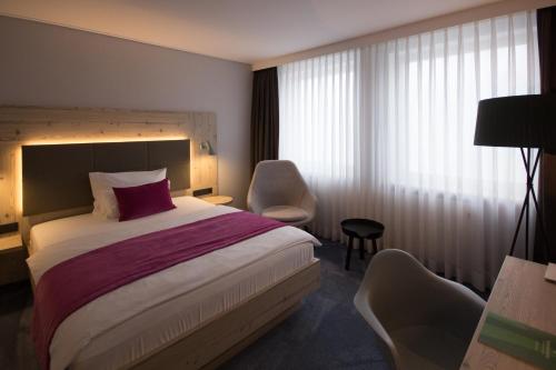 a hotel room with a bed and a chair at FischerS in Kassel