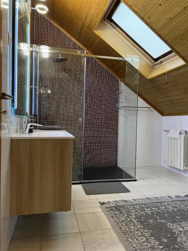 a bathroom with a glass shower and a sink at Estrela da Montanha in Penhas da Saúde