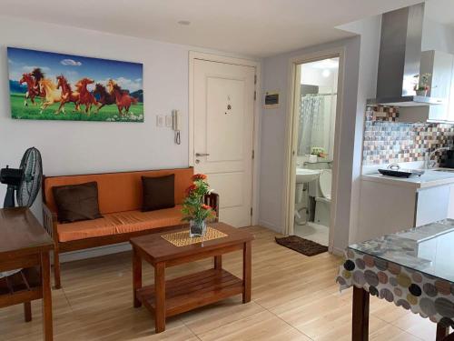 a living room with a couch and a table at AZURE C1 with balcony wifi MULTIPLE UNITS near airport in Manila