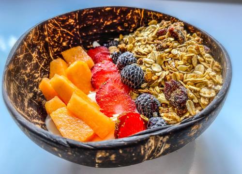 a bowl of granola and fruit on a table at Tityra Lodge in Monteverde Costa Rica