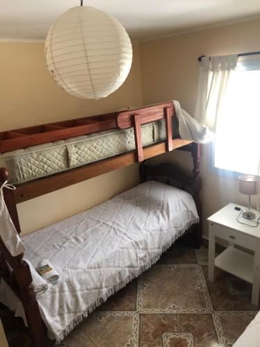 a bunk bed in a room with a lamp at ROMA in Reyes