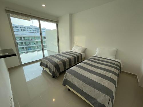 Łóżko lub łóżka w pokoju w obiekcie Morros Ultra 810