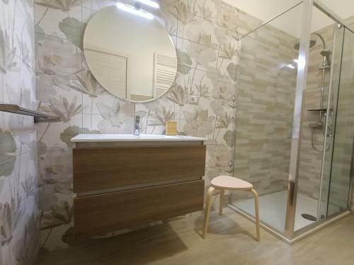 a bathroom with a sink and a mirror and a stool at RossoMattone CountryHouse in Sulmona