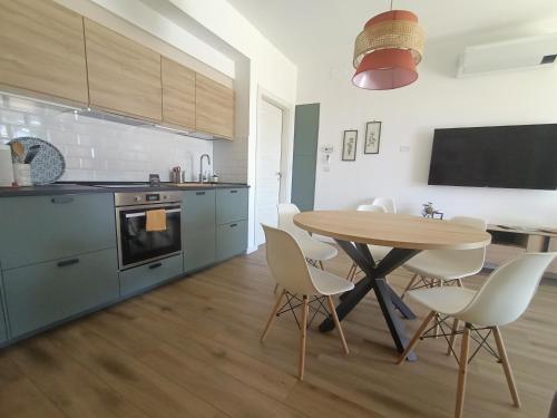 a kitchen with a table and chairs in a room at RossoMattone CountryHouse in Sulmona