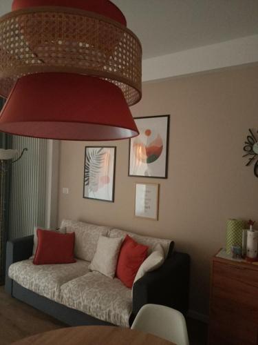 a living room with a couch under a large red light at RossoMattone CountryHouse in Sulmona