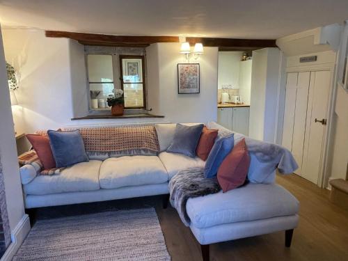 a living room with a couch and two chairs at HEBE COTTAGE - Idyllic and homely with attention to detail in Atworth