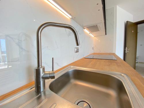 a kitchen with a sink and a counter top at Paradiso Aparthotel - Private apartment -BSR-2 in Nesebar