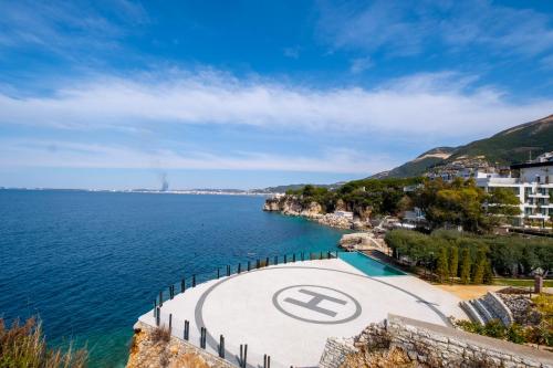 a view of a body of water with a sign on it at Sunset House in Vlorë