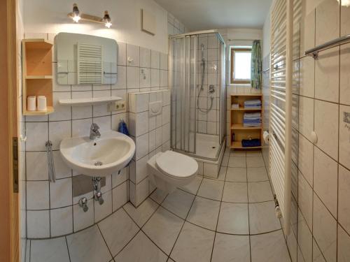 a bathroom with a toilet and a sink and a shower at Beim Wirtschmied - Chiemgau Karte in Inzell