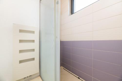 a bathroom with a door and a window at Villa Frida in Zambratija