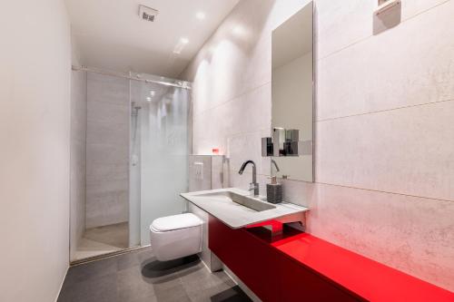 a bathroom with a toilet and a sink and a shower at Villa Frida in Zambratija