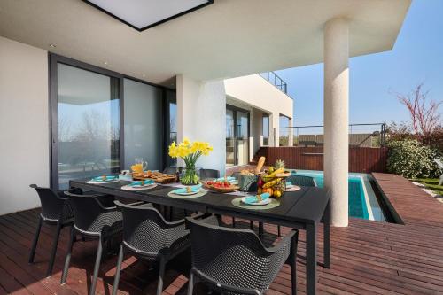 a black table with food and flowers on a patio at Villa Frida in Zambratija