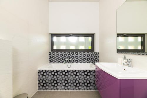 a bathroom with a tub and a sink at Villa Frida in Zambratija