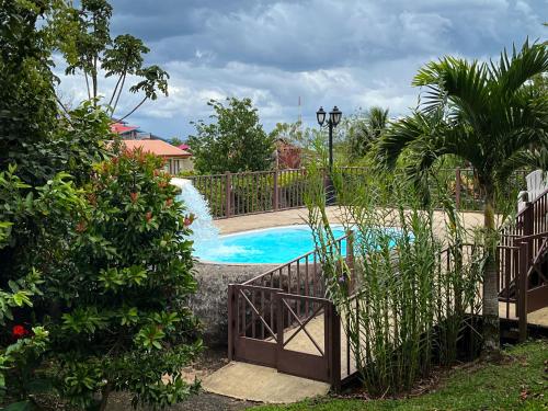 a swimming pool with a waterfall in a yard at Legacy Boutique Hotel in Quesada