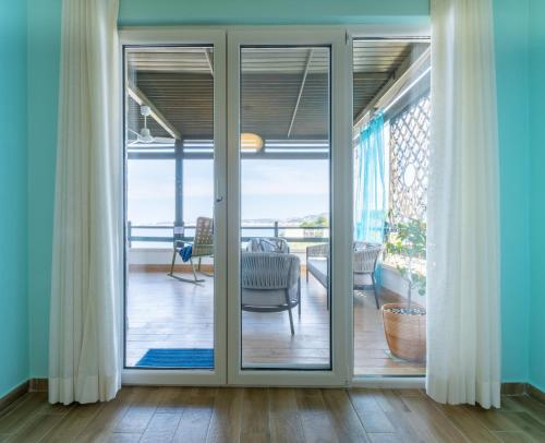 a sliding glass door leading to a living room at Sunset House in Vlorë