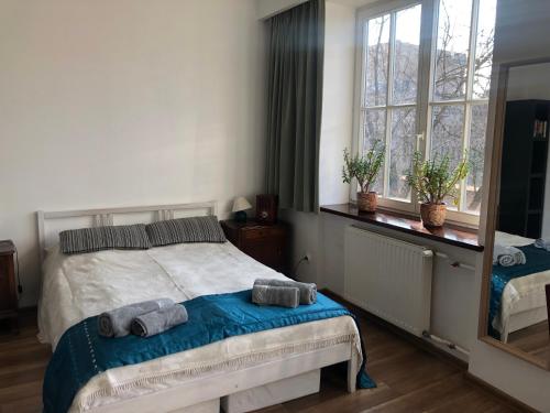 a bedroom with a bed with two towels on it at Apartament Teatralny in Gdańsk