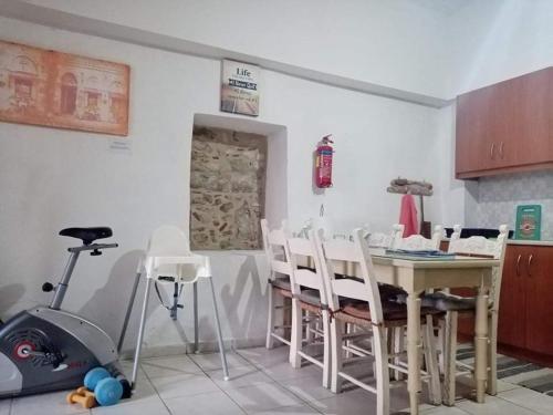 a kitchen with a table and chairs and a stove at H&M Prive HOME MÀRGARITES RETHYMNO 115sqm in Margarítai