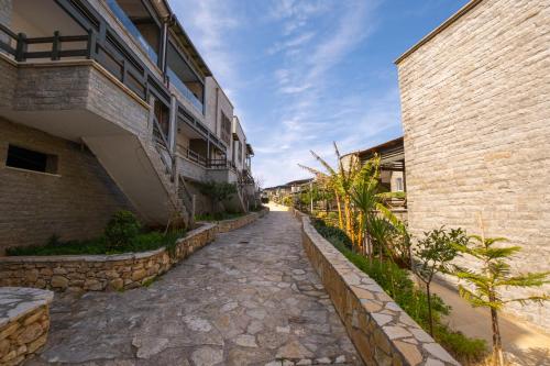 a cobblestone street between two buildings at Sunset House in Vlorë
