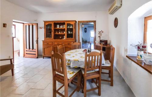 a dining room with a table and chairs and a kitchen at Beach Front Home In Lovran With Wifi in Lovran