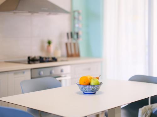 a bowl of fruit on a table in a kitchen at Sunset House in Vlorë