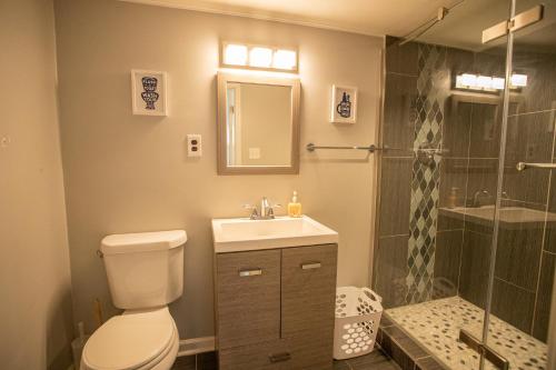 a bathroom with a toilet and a sink and a shower at The Retreat at Graceland in Memphis