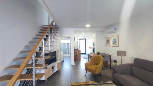 a living room with a staircase and a couch at Atlantic Valley in Furnas