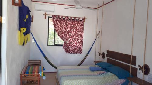a bedroom with two beds and a hammock at EncantaLuna in Holbox Island