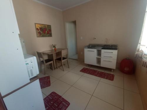a kitchen with a table and a stove top oven at Jockey Apto 2 in Campos dos Goytacazes