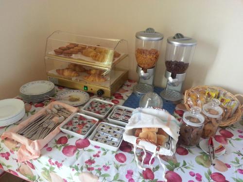 a table topped with lots of trays of pastries at B&B L'Isola in Porto Cesareo