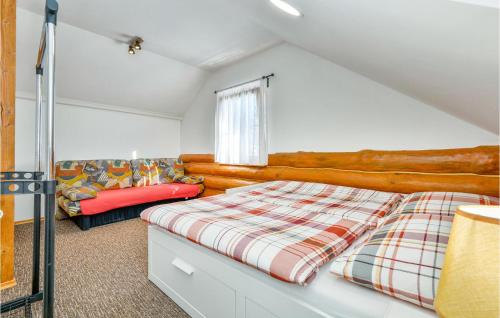 a bedroom with a bed and a couch at Lovely Home In Vinogradi Ludbreski in Ludbreg