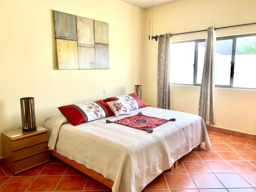 a bedroom with a bed and a window at Casa Fraile San Miguel in San Miguel de Allende