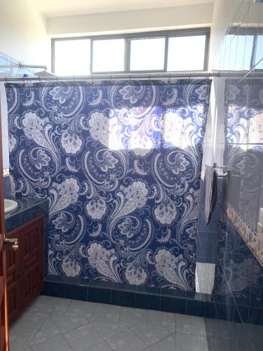 a bathroom with a blue and white patterned wall at Casa Fraile San Miguel in San Miguel de Allende