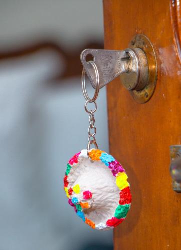a key chain hanging from a wooden door at Hotel Al kassaba in Chefchaouene