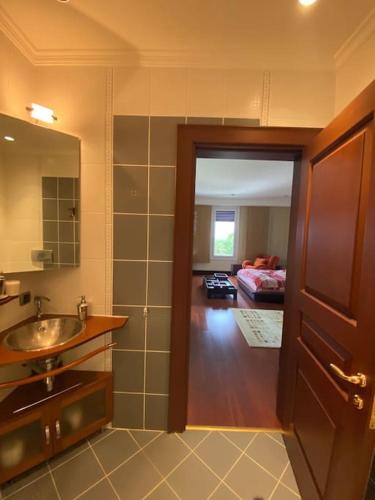 a bathroom with a sink and a door to a room at Silivri Gazitepe'de 3 katlı, havuzlu lüks villa in Silivri