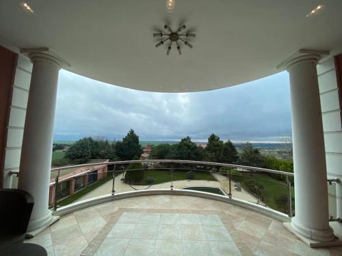 a view of a balcony with a clock on the ceiling at Silivri Gazitepe'de 3 katlı, havuzlu lüks villa in Silivri