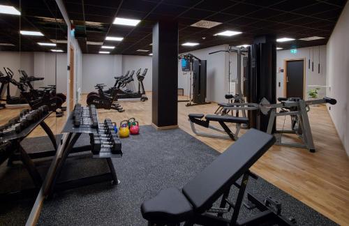 a gym with several treadmills and exercise machines at Scandic Örebro Central in Örebro